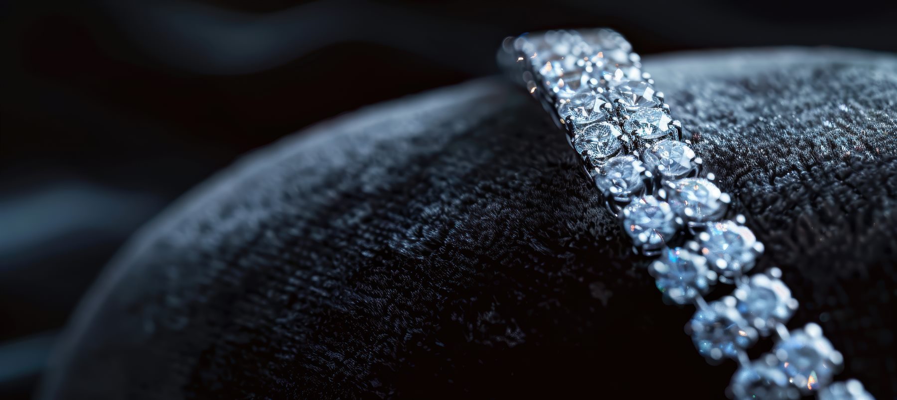 Diamond bracelet resting on a dark cushion
